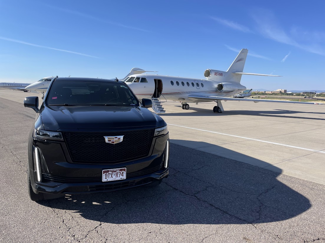 Private aviation ground transfer Denver — Cadillac Escalade ESV staged planeside at Centennial Airport APA