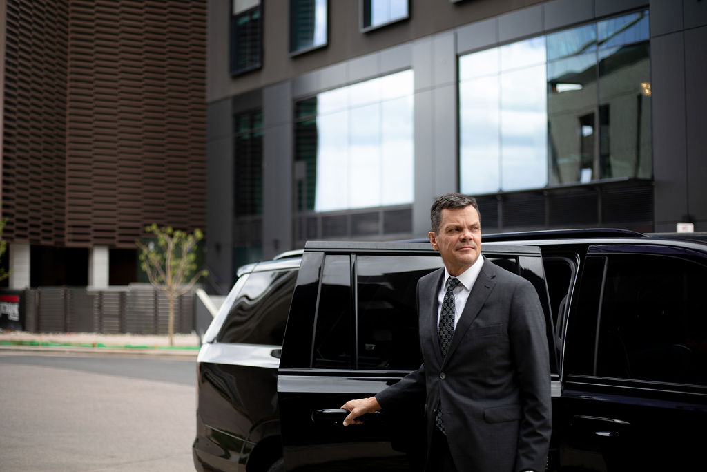 Executive assistant corporate travel Denver luxury chauffeur Cadillac Escalade